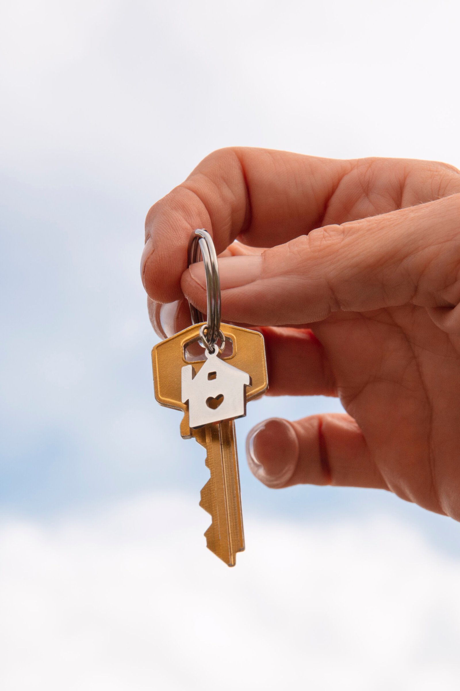 Hand Holding Key Outdoors(1)